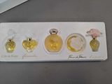 a tray with three perfume bottles on it on a table
