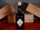 a bottle of wine sitting on a table next to a box