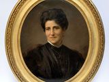 portrait of a woman in a black dress in a gold frame
