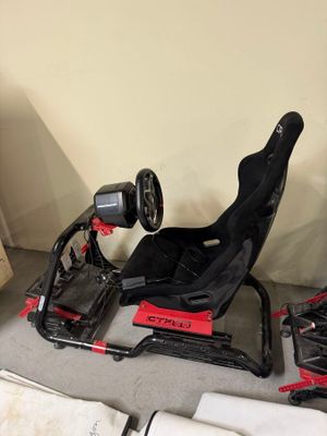 a red and black race car with a steering wheel and a steering wheel