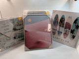 three cd ' s are sitting on a table with a white table top