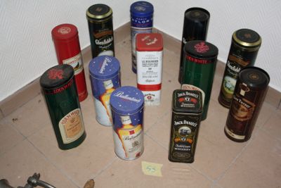 many different types of tins on the floor next to each other