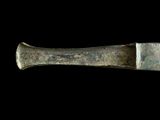 a close up of a knife on a black background