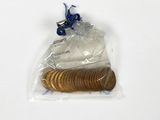 a bag of coins sitting on top of a white table