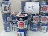 many cans of blue paint on a white table