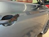 a sticker on the door handle of a car