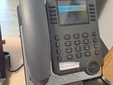 a telephone that is sitting on a desk next to a keyboard
