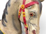 statue of a horse with a red bridle on its head