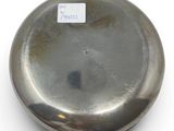 a silver plate with a sticker on it on a white surface