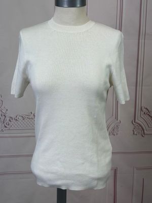 the top of a white shirt is on a mannequin stand