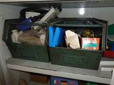 two green bins filled with items on a shelf