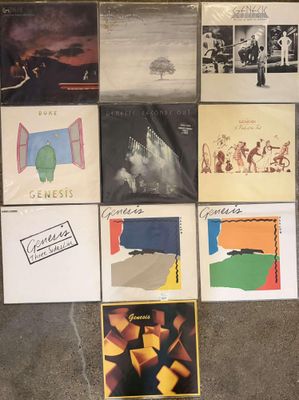 several albums are arranged on the floor in front of a wall