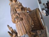 a statue of a woman holding a pot and a bird