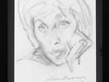 pencil drawing of a woman ' s face on a piece of paper