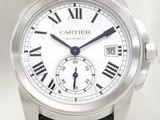 a silver wrist watch with roman numerals on it