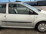 a small silver car that is parked in a parking lot