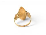 a close up of a gold ring on a white surface