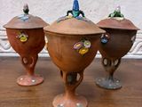 three small pots sitting on top of a wooden table