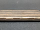 an old silver cigarette case sitting on top of a table