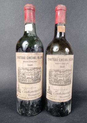 two bottles of wine are sitting next to each other on a table