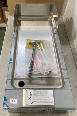 a stainless steel sink sitting on a counter in a room