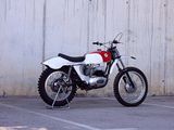 a motorcycle parked in a parking lot next to a wall
