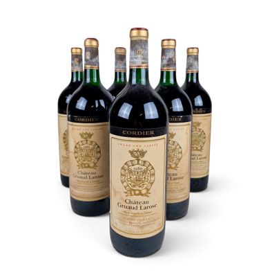 four bottles of wine are lined up on a white surface