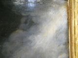 une photo d'un tableau représentant un chat, dans un cadre doré