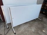 two white boards sitting on top of each other in a garage