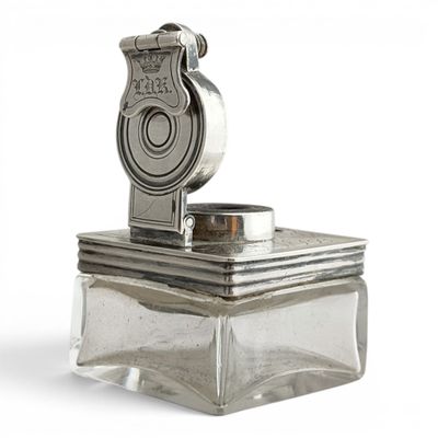 a silver object with a coin on top of it