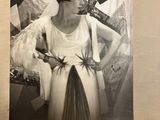 a black and white photo of a woman in a dress