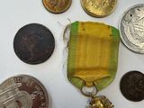 a lot of coins and a medal on a table