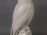 white owl on a rock statue on a gray background