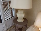 a lamp that is sitting on a table next to a couch