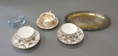 three cups and saucers on a table with a tray