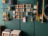 a green wall with a bunch of items hanging on it