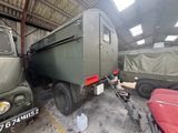 two army vehicles parked in a garage next to each other