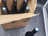 six bottles of beer in a cardboard box on the floor