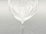 a wine glass with a red label on it