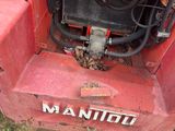 a red machine that is sitting in the grass