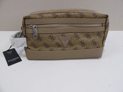 a brown and tan purse with a small tag on it