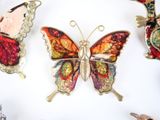 a lot of different colored butterflies on the table