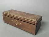 an old wooden box sitting on top of a gray surface