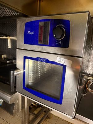 silver and blue ovens in a commercial kitchen with tile flooring