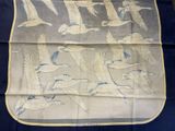 an image of a blue and white table cloth with a flock of birds on it
