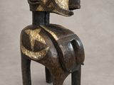 wooden sculpture of a horse with gold paint on it ' s body