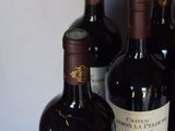 several bottles of wine are lined up on a table