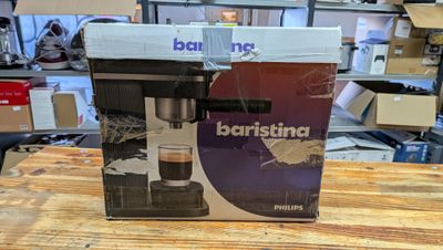 a box with a coffee machine on a table