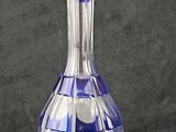 a blue glass decanter sitting on a black surface