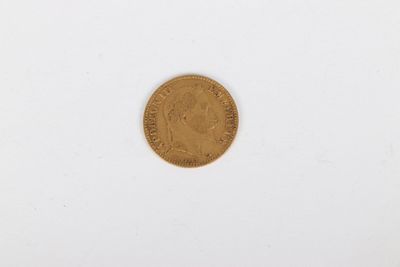 a close up of a gold coin on a white surface